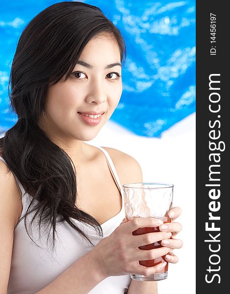 Young Woman Enjoying Healthy Drink In Studio At Camera