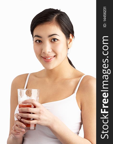 Young Woman Enjoying Healthy Drink In Studio