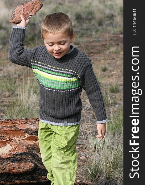 Beautiful blond boy playing outdoors on a spring day. Beautiful blond boy playing outdoors on a spring day