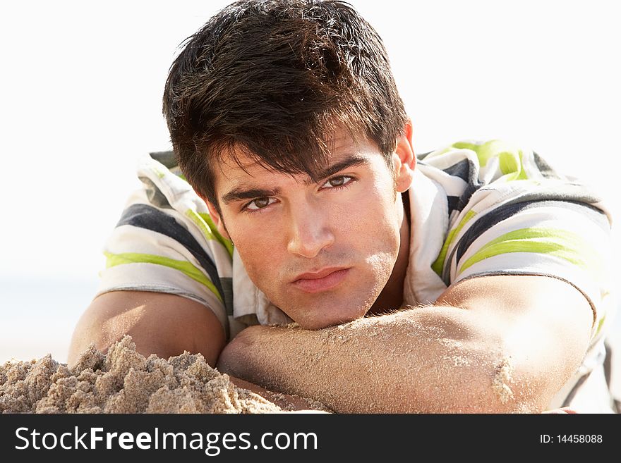 Teenage Boy Sitting On Beach