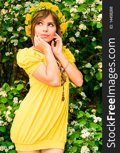 Thoughtful young woman in dandelion garland. Thoughtful young woman in dandelion garland