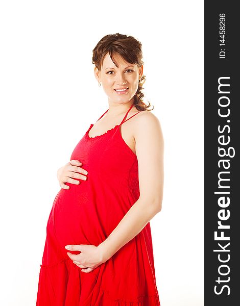 Beautiful young brunette pregnant woman wearing a red dress. Beautiful young brunette pregnant woman wearing a red dress