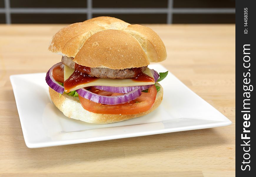 A freshly made American style hamburger with sauce