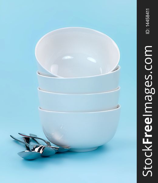 Plates and cutlery isolated against a blue background