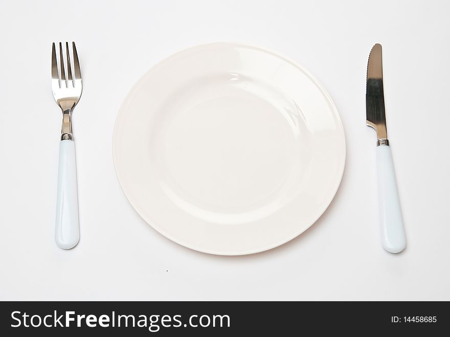 Set of kitchen object. The spoon, a fork separately on a grey background. Set of kitchen object. The spoon, a fork separately on a grey background.