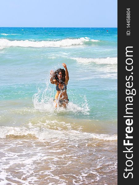 Pretty brunette girl in blue sea. Pretty brunette girl in blue sea.