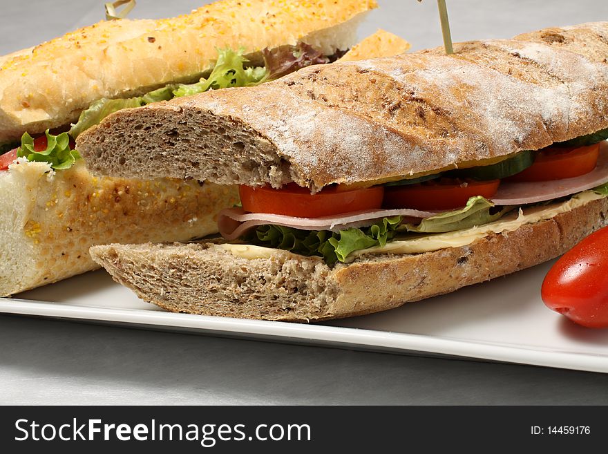 Dark baguette with with ham, vegetables and tomatos