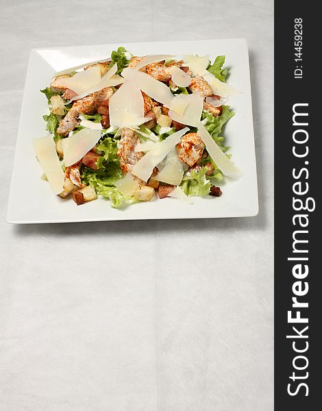 White plate with chicken vegetables salad. White plate with chicken vegetables salad