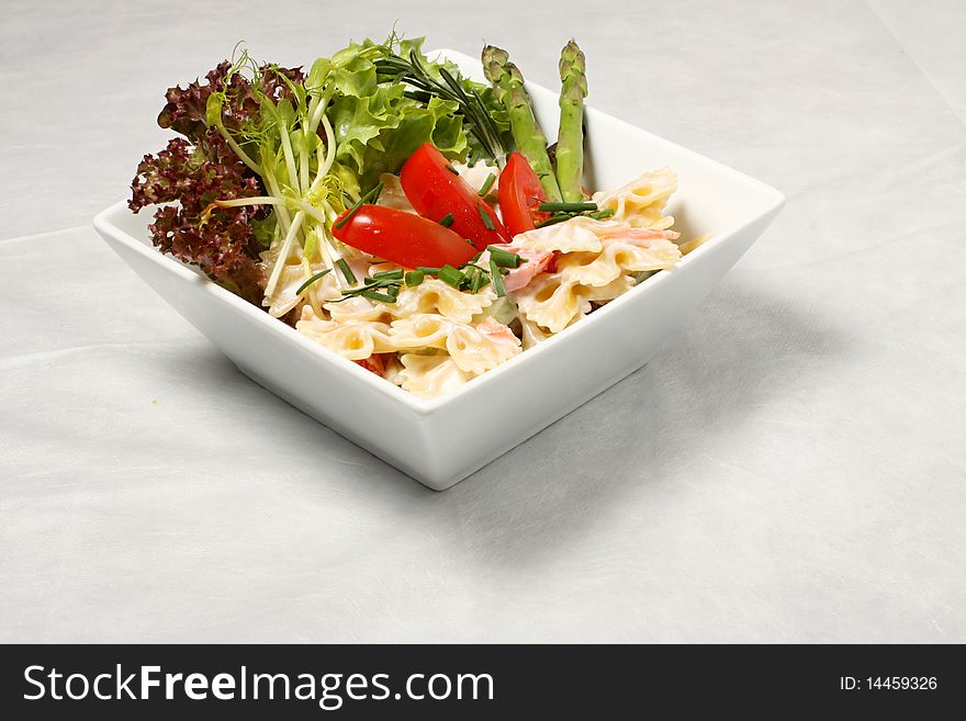 Vegetables and pastries salad with green leaves