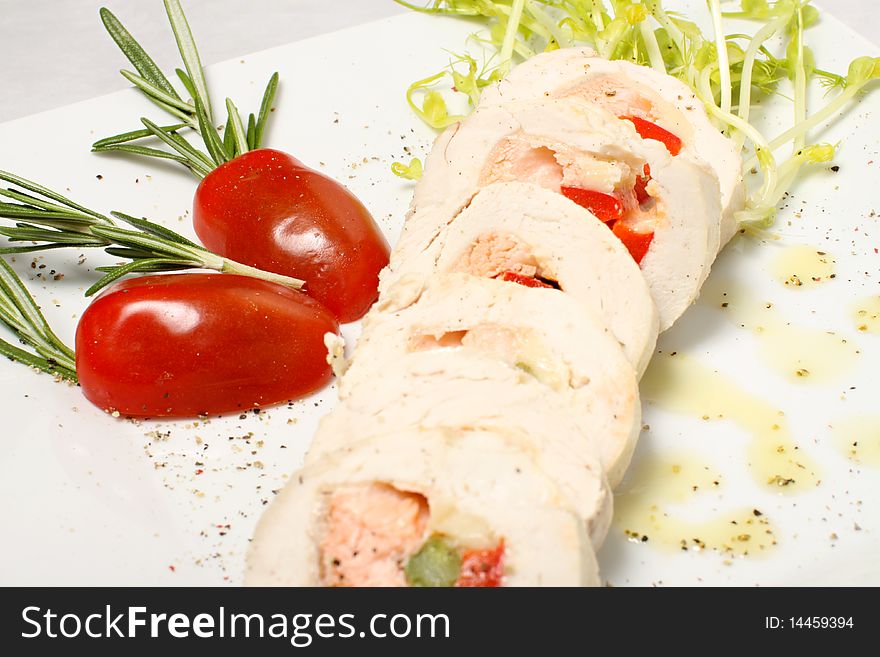 Chicken roll detail with red tomatos