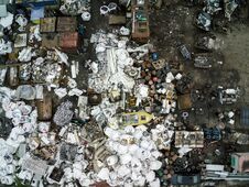 Scrap Metal Junkyard Area Aerial View. Reception And Storage Metal Waste Before Recyclyng.Dark Toned Royalty Free Stock Photos
