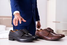 Free The Young Handsome Businessman Choosing Shoes At Home Stock Image - 144540751