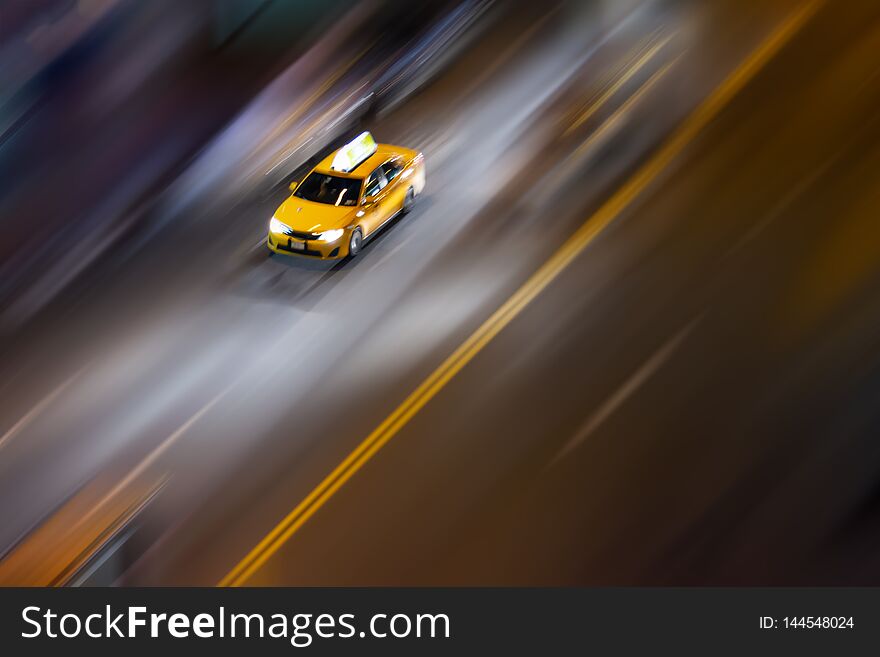 Overhead view of New York City taxi driving down the street