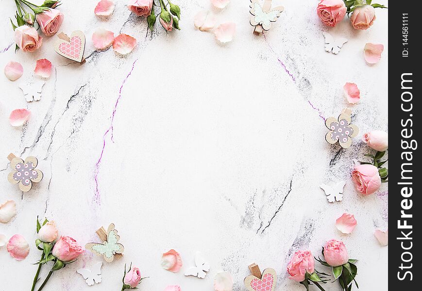 Spring holiday theme, pink roses and  decorations  on a white marble background