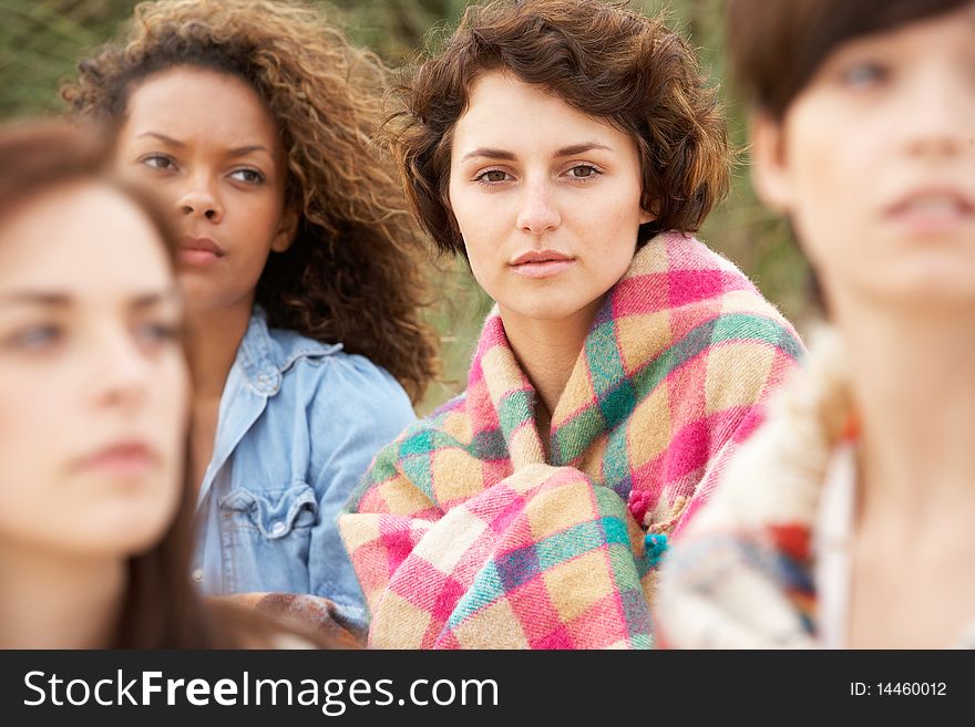 Close Up Of Group Of Girls Sitting On Beach Together