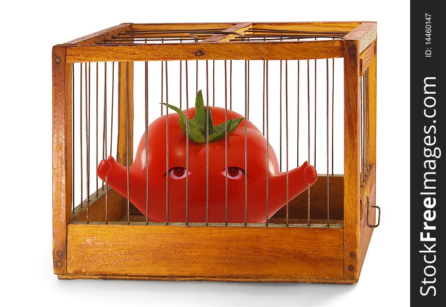 Tomato, prisoner in the cage made of wood with iron rods, isolated. Tomato, prisoner in the cage made of wood with iron rods, isolated