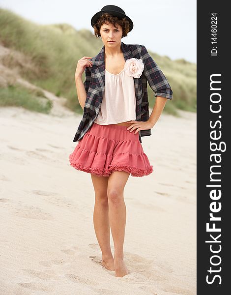 Fashionably Dressed Attractive Young Woman Standing Amongst Sand Dunes. Fashionably Dressed Attractive Young Woman Standing Amongst Sand Dunes