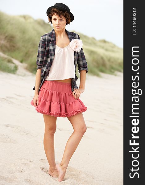 Fashionably Dressed Attractive Young Woman Standing Amongst Sand Dunes