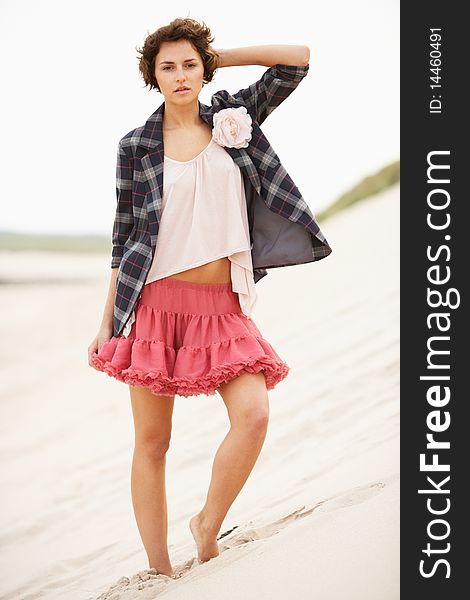 Attractive Young Woman Standing Amongst Sand