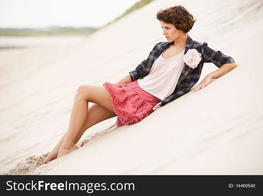 Fashionably Dressed Attractive Young Woman Standing Amongst Sand Dunes. Fashionably Dressed Attractive Young Woman Standing Amongst Sand Dunes