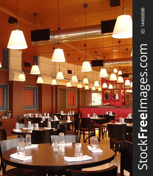 Restaurant with a lot of lamps on the ceiling