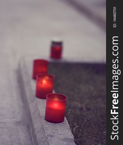 Set of red candles on the street.