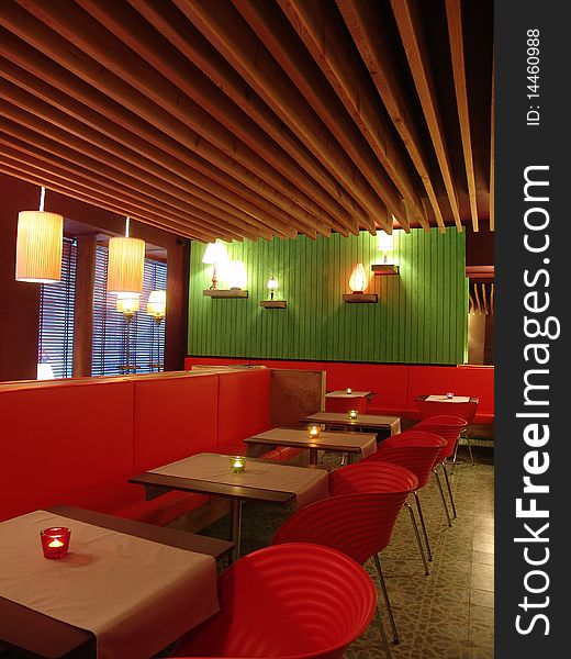 View of restaurant in modern style with red chairs