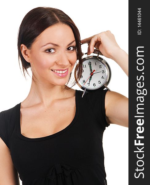 Beautiful young woman listening to the ticking of alarm clock. Beautiful young woman listening to the ticking of alarm clock