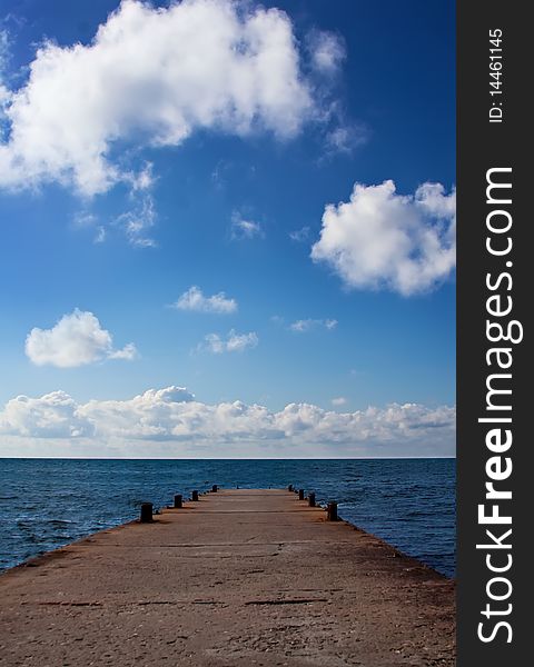 Blue Sea With Clouds And Pier