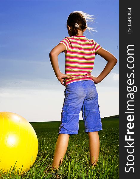 Girl with yellow ball in field. Girl with yellow ball in field
