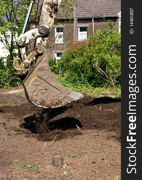 An excavator working in a garden