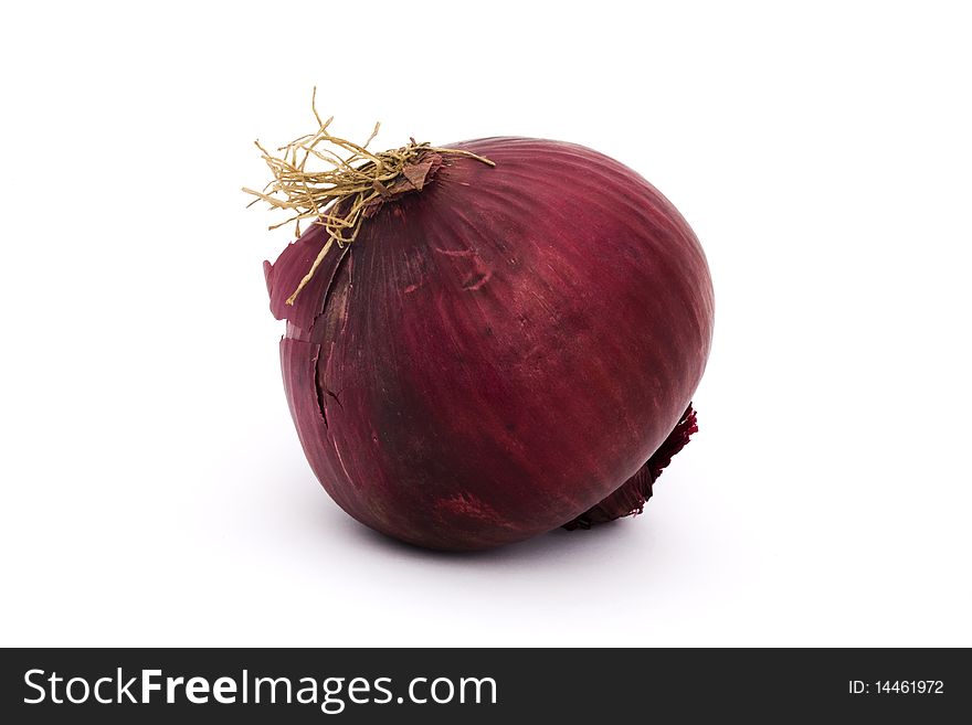 Whole organic red onion on a white background