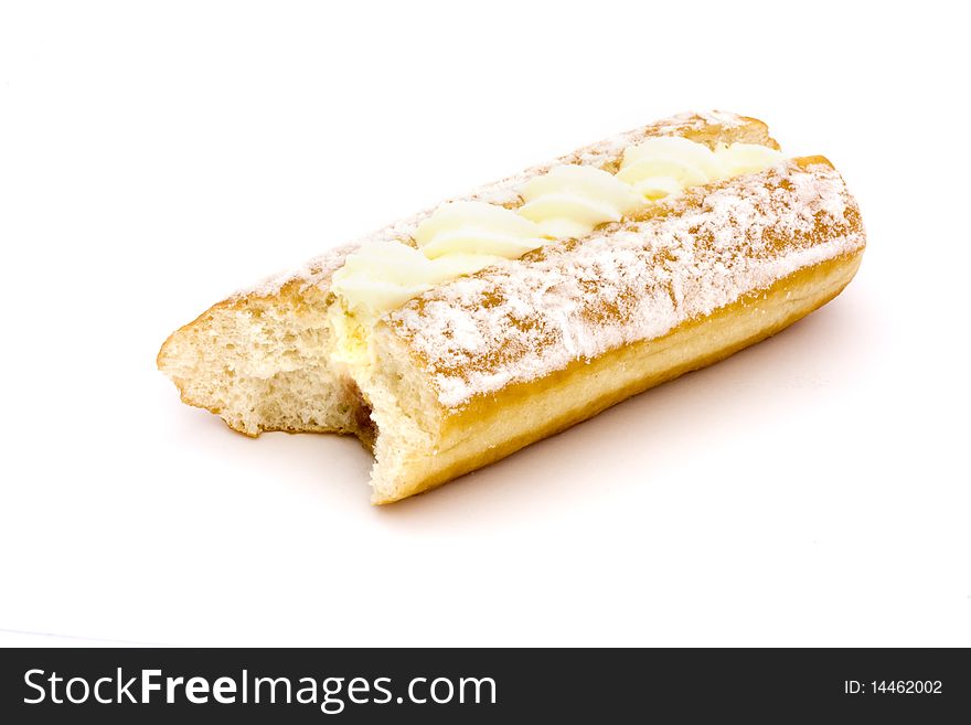 Cream cake with a bite taken out on a white background. Cream cake with a bite taken out on a white background