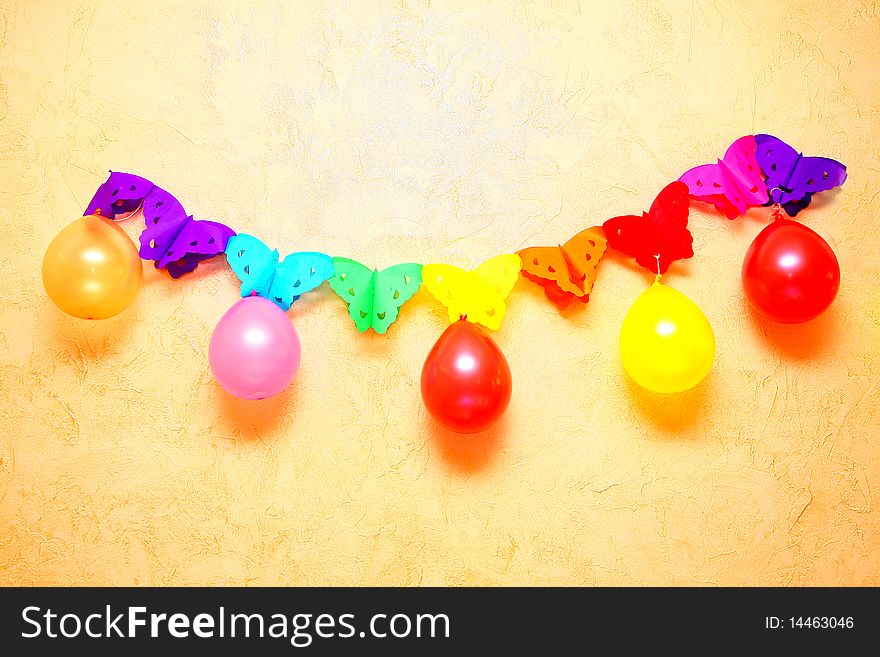 Colour, inflatable spheres hang on a wall