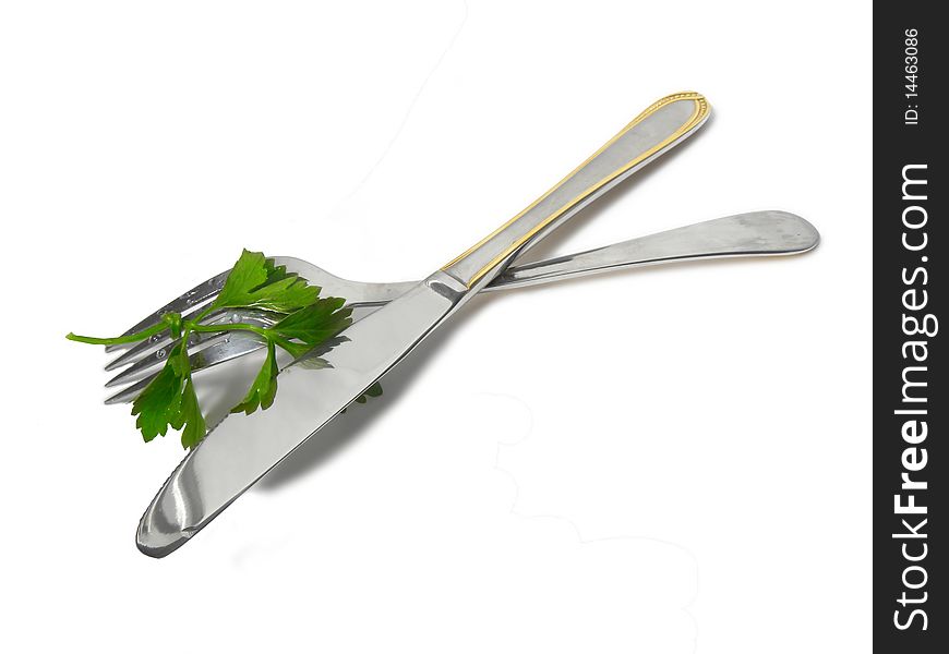 Fork and knife with sprig of parsley  isolated on white background