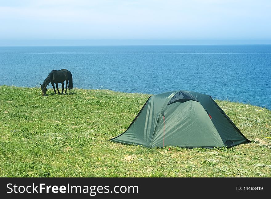 Tourist tent on seashore in the sunshine day