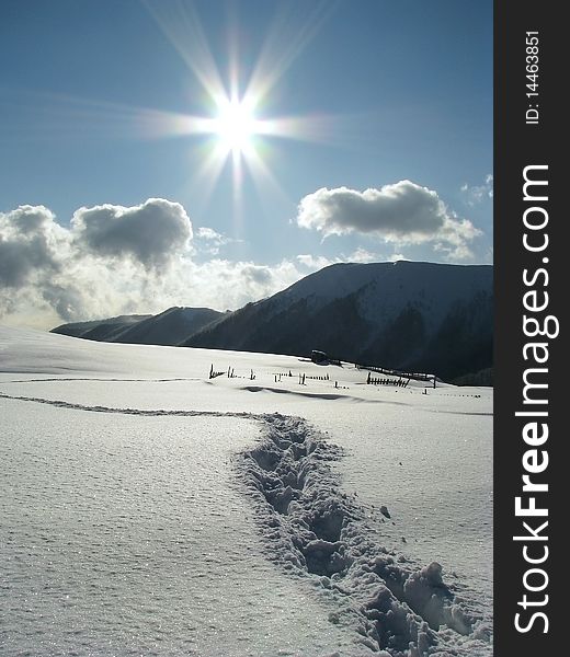 Sunny day in the Carpathian Mts. Footprints in the snowbound mountains. Sunny day in the Carpathian Mts. Footprints in the snowbound mountains