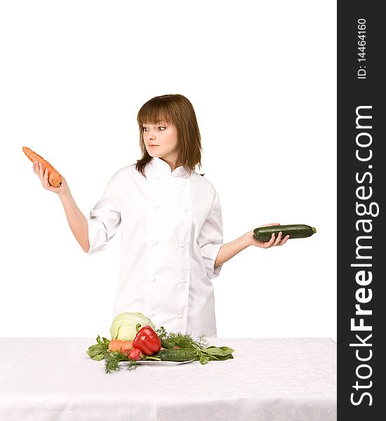 Cook girl holding squash and carrots - isolated on white