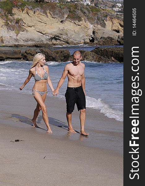 Young attractive couple enjoying an afternoon at the beach. Young attractive couple enjoying an afternoon at the beach