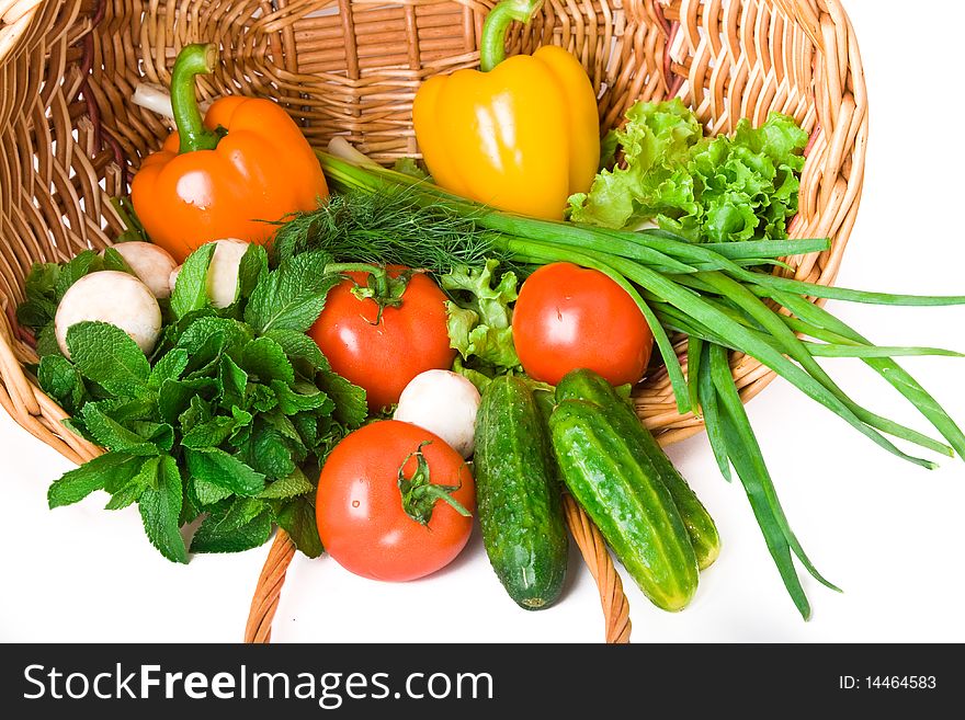 Basket with vegetables isolated on white background.