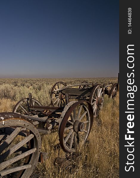 Discarded Old Wooden Wagons aligned in the countryside of oregon,