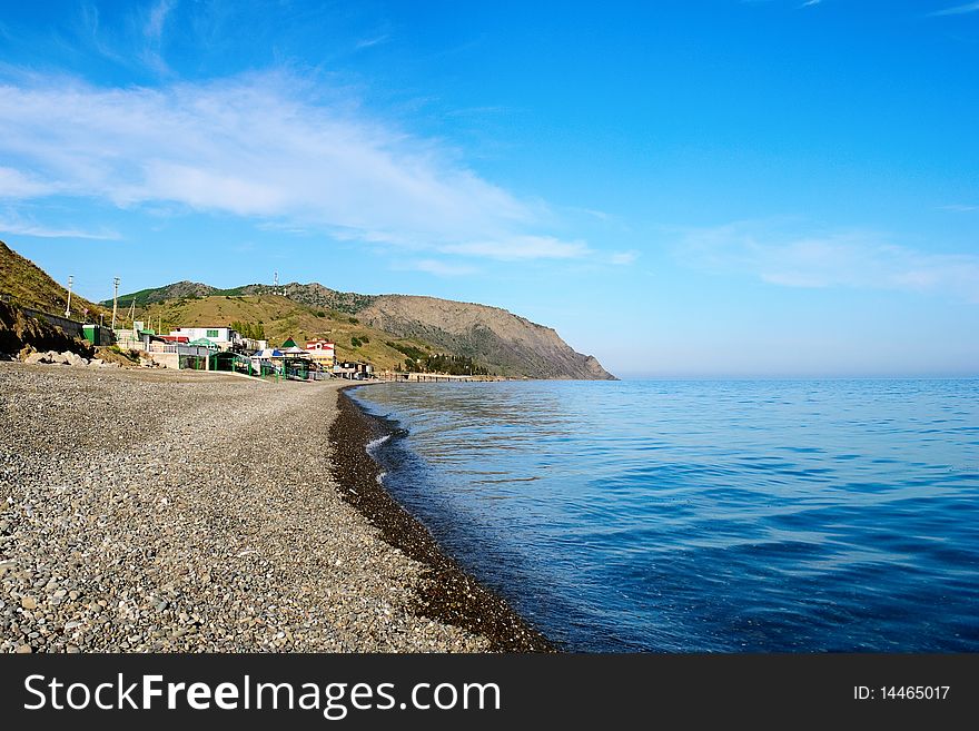 Pebble beach in the village Morskoye on the Black Sea in Crimea