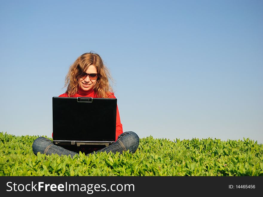 The beautiful girl with the laptop in the field. The beautiful girl with the laptop in the field