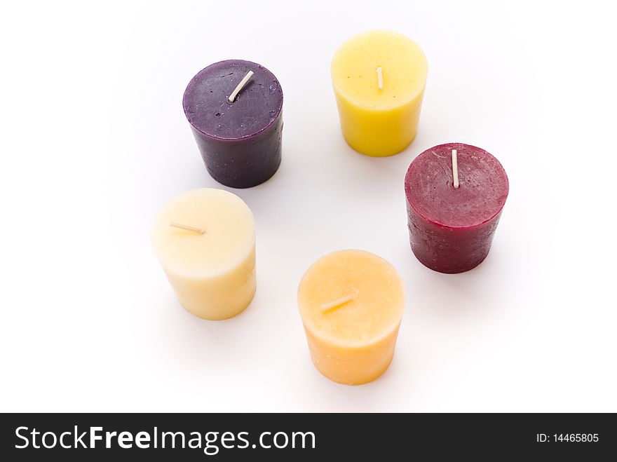 Five multi-colored candles on a white background. Five multi-colored candles on a white background