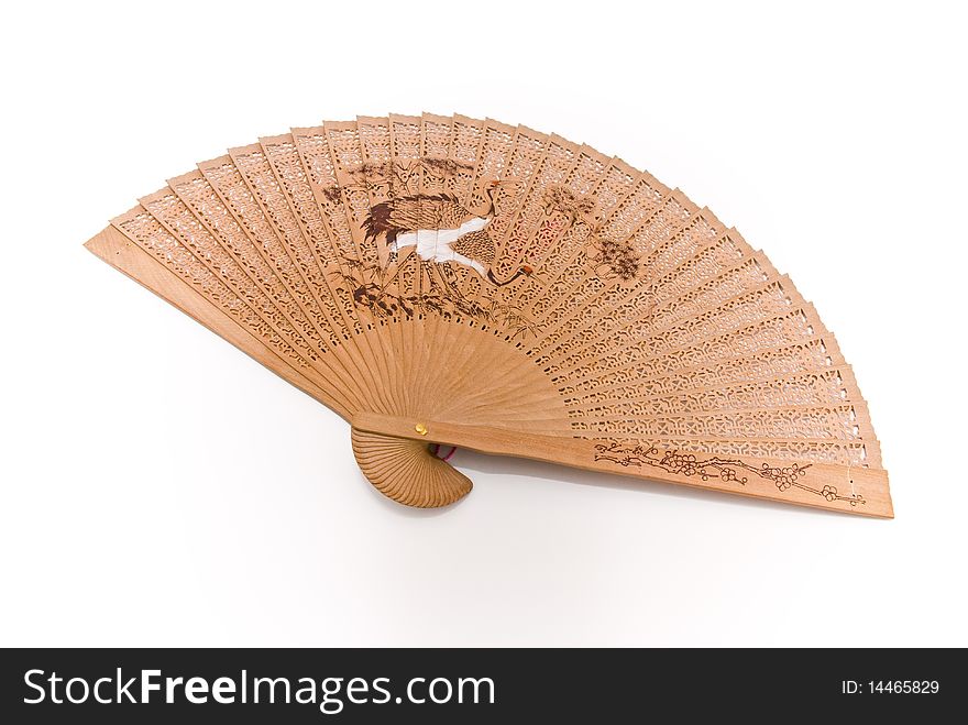 Wooden fan with thread and pattern in Oriental style with a white background. Wooden fan with thread and pattern in Oriental style with a white background