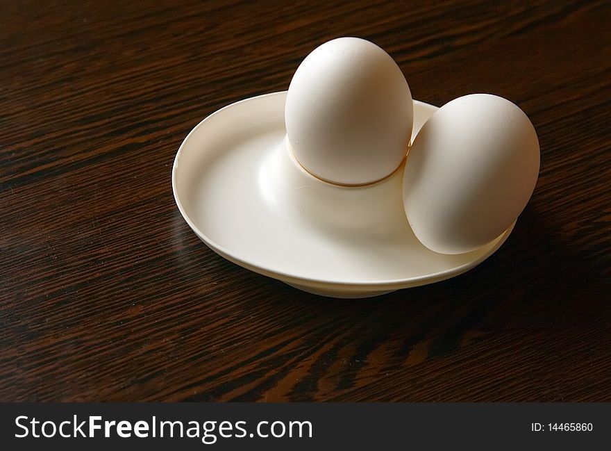 Breakfast of two boiled eggs in a white eggcup