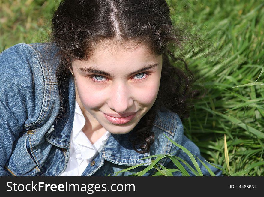 Smiling young  girl on the grass  background