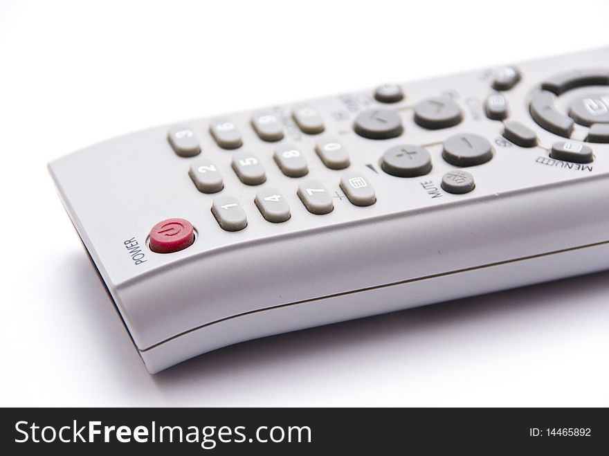 Remote Control of plastic gray with colored buttons on a white background, close-up. Remote Control of plastic gray with colored buttons on a white background, close-up