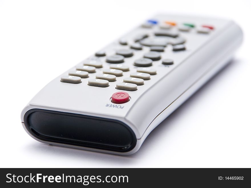 Remote Control of plastic gray with colored buttons on a white background, close-up. Remote Control of plastic gray with colored buttons on a white background, close-up