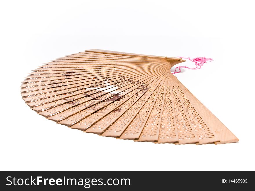 Wooden fan with thread and pattern in Oriental style with a white background. Wooden fan with thread and pattern in Oriental style with a white background